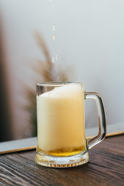 A glass of light beer on the table