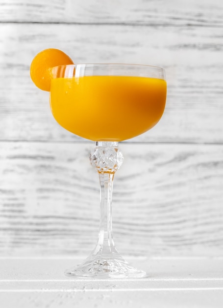 Glass of Mango Cocktail on the white surface