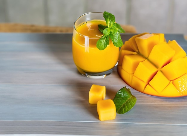 Glass of mango juice in summer with mint leaves