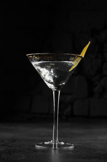 Glass margarita alcohol coctail drink with citrus on a gray surface. Chalet.