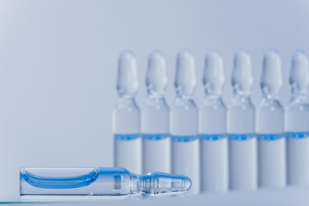 glass medical ampoule vial for injection medicine is liquid sodium chloride with of aqueous solution in ampulla close up bottles ampule multicolor on background color and water human plasma