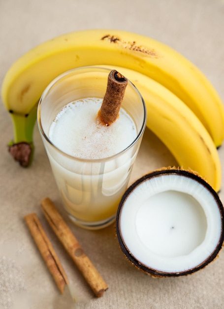 Стакан молока рядом с бананом и стакан молока.