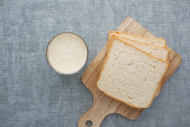 Glass of milk and bread on table