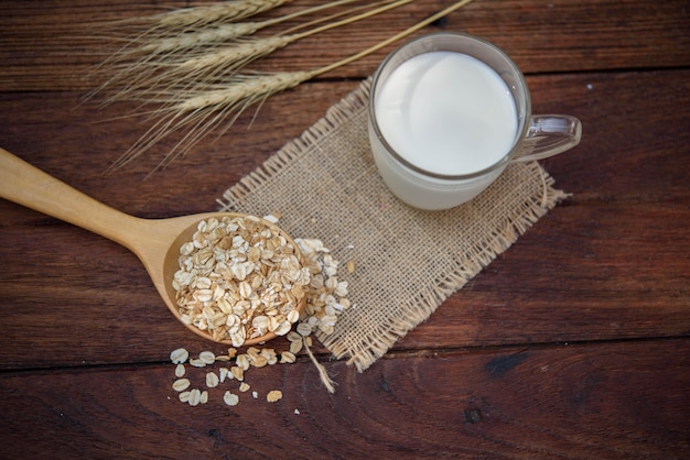 Glass of milk and grain on the table.