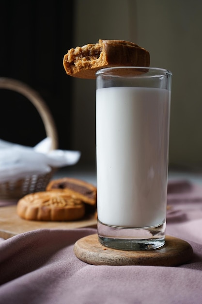 A glass of milk and a half of traditional mooncake