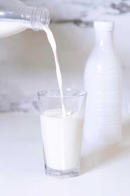 A glass of milk is poured into a glass