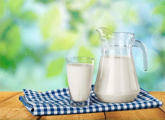 Glass of milk and jug on  table