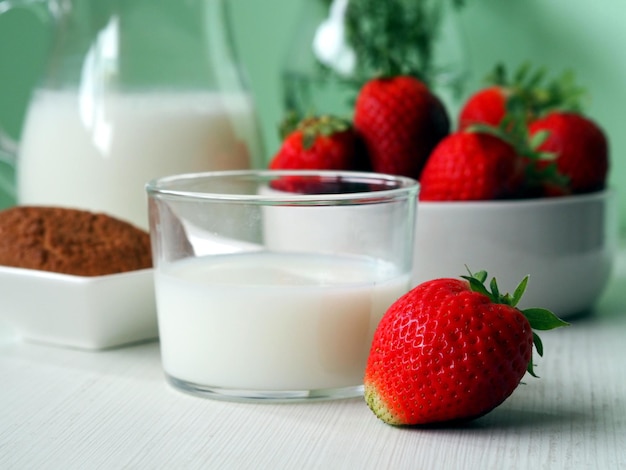 Glass of milk and strawberries