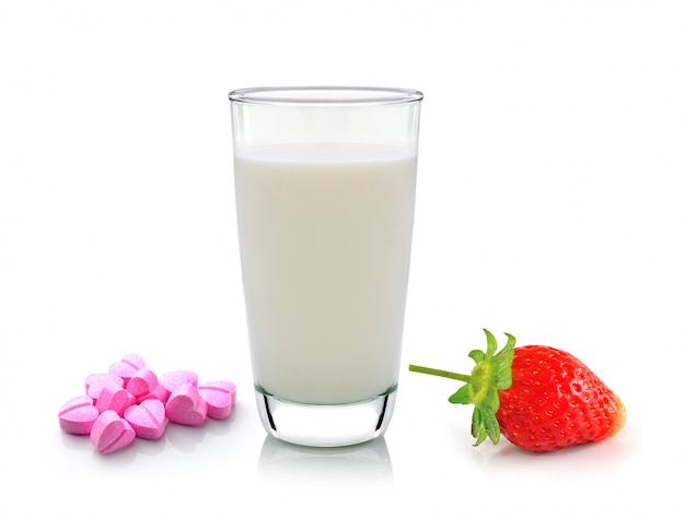 Glass of milk vitamin c and strawberry on white