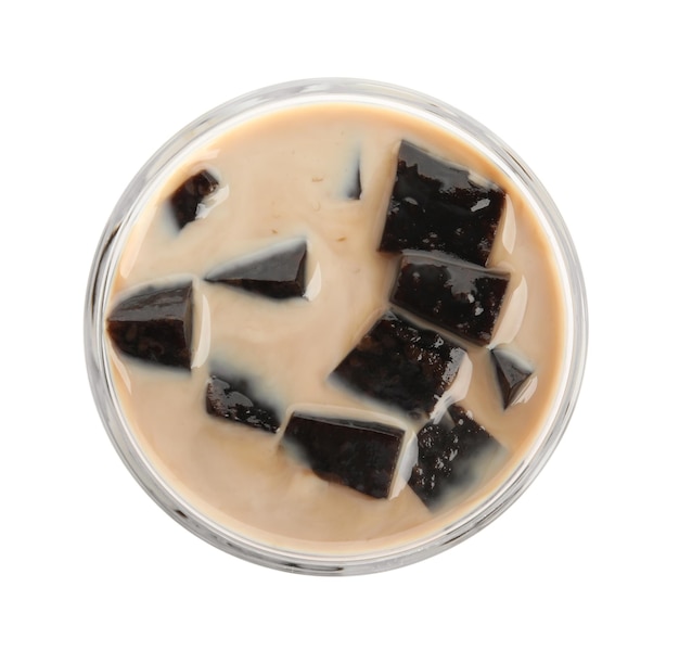 Glass of milk with grass jelly isolated on white top view