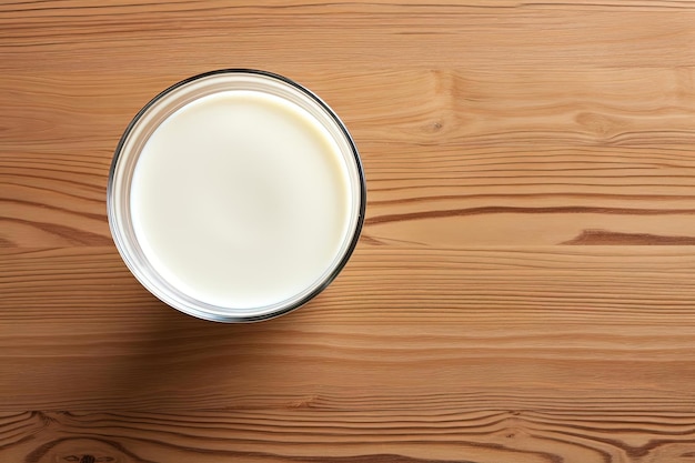 Photo a glass of milk on a wooden table for sale in the style of aerial view