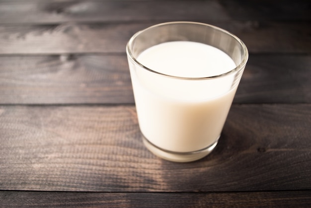 Glass of milk on wooden table