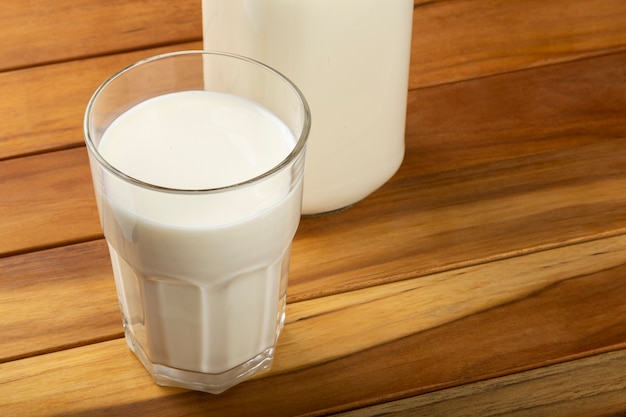 Glass of milk on the wooden table