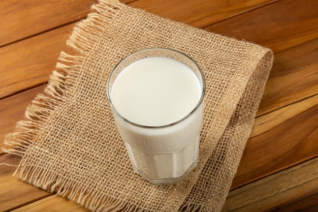 Glass of milk on the wooden table