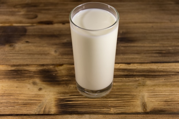 Glass of milk on wooden table