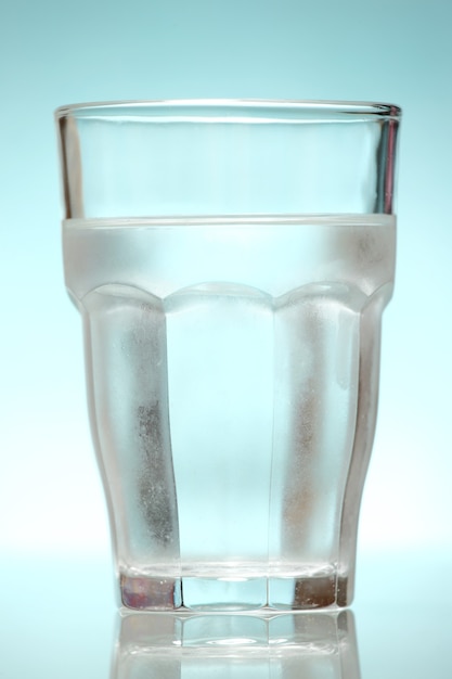 A glass of mineral water over blue background