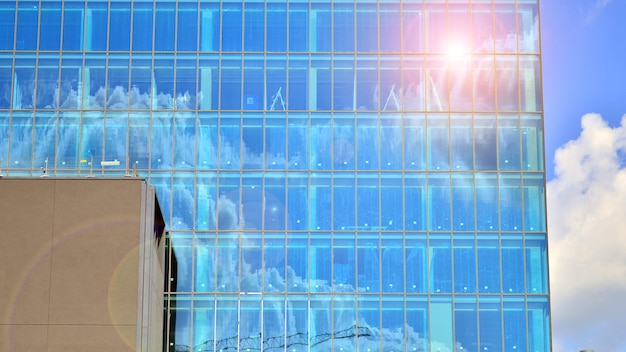 Glass modern building with blue sky background View and architecture details Urban abstract