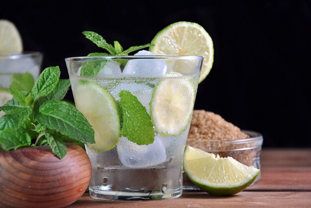 Glass of mojito cocktail with mint, lime and sugar