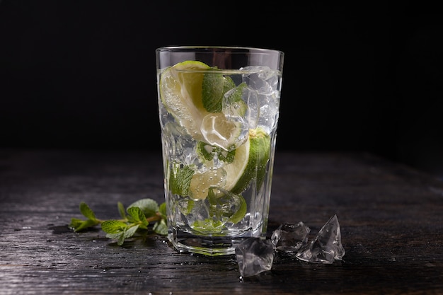 Glass of mojito with lime and mint ice cubes