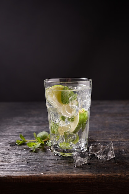 Glass of mojito with lime and mint ice cubes