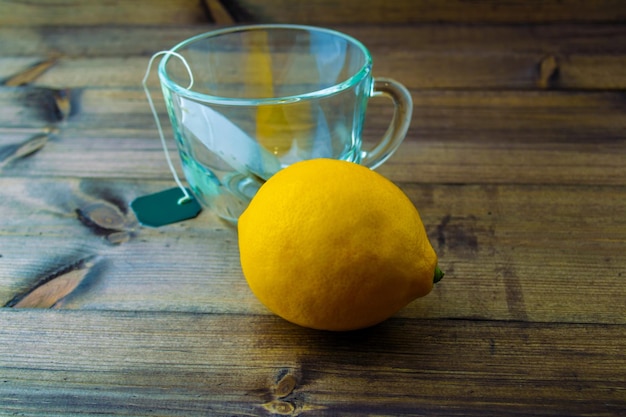 Glass mug with tea bag and lemon