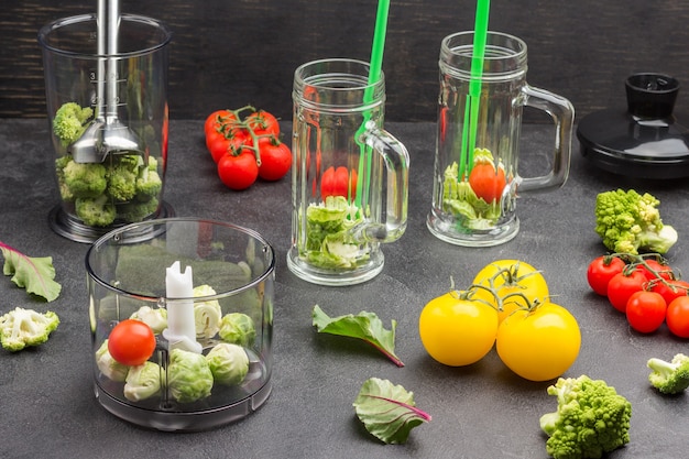 Glass mugs with broccoli and green straws.