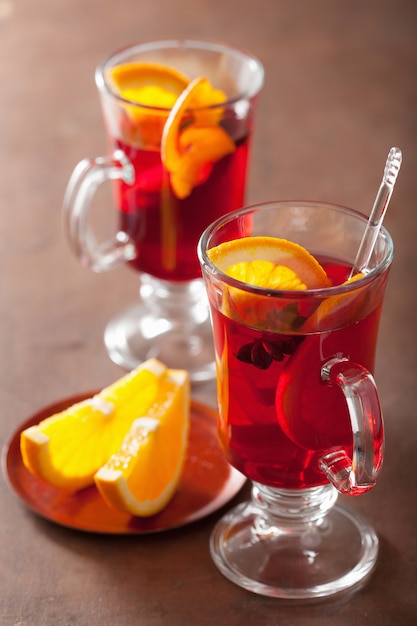 Glass of mulled wine with orange and spices, winter drink