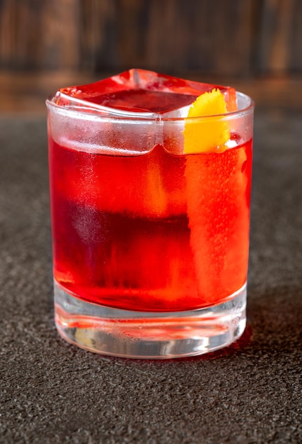 Glass of Negroni cocktail garnished with orange peel