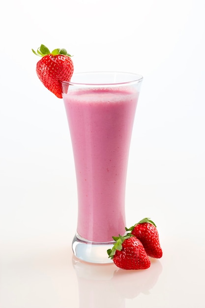 Glass of nutritious milkshake made with fresh strawberries on white background