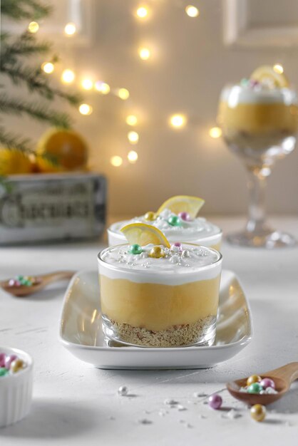 A glass of oatmeal with a lemon wedge on the side.