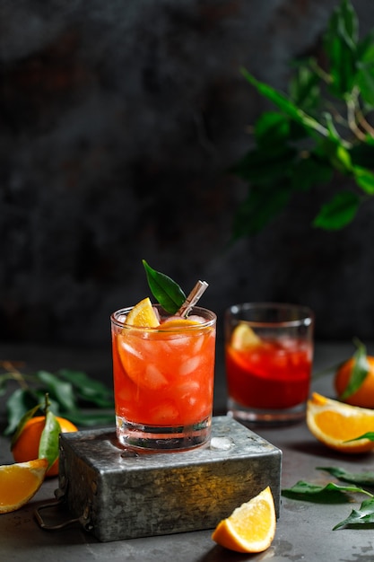 Glass of orange cocktail with ice cubes 