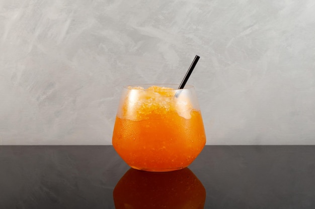 Glass of Orange Granizado Traditional Spanish summer iced drink Slushie fruit drink Sweet Shaved ice