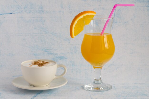 A glass of orange juice and a cup of coffee