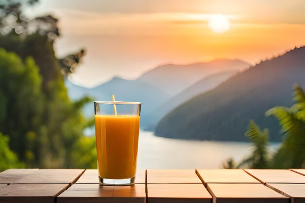 A glass of orange juice is on a table with a view of a lake and mountains in the background