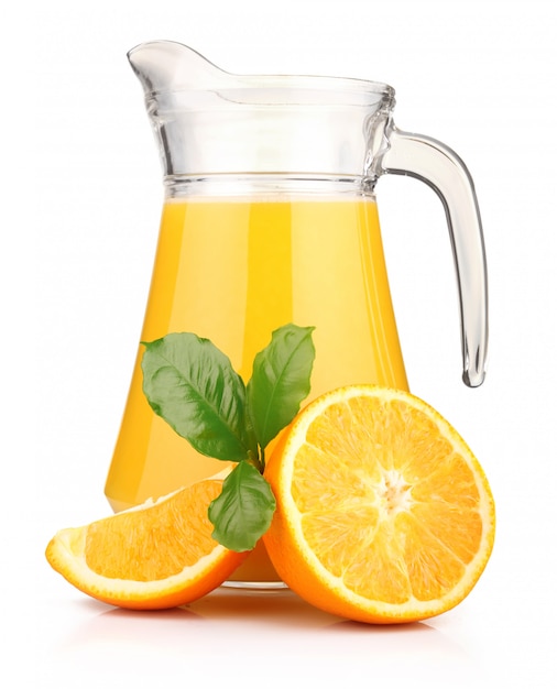 Glass of orange juice and orange fruits with green leaves isolated