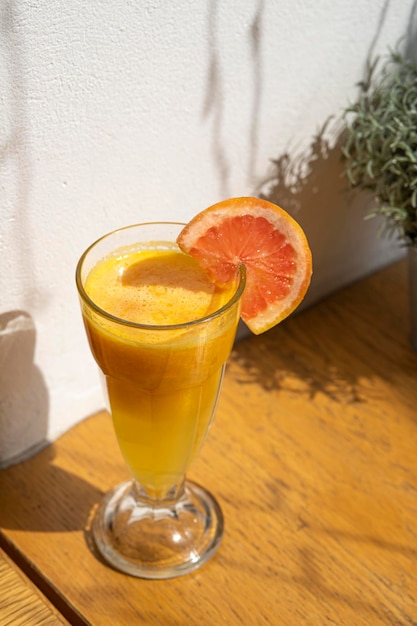 glass of orange juice and orange