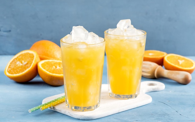 Glass of orange juice with ice cubes Cold orange fresh Glass of orange juice for hot summer day