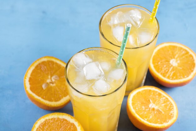 Glass of orange juice with ice cubes Cold orange fresh Glass of orange juice for hot summer day