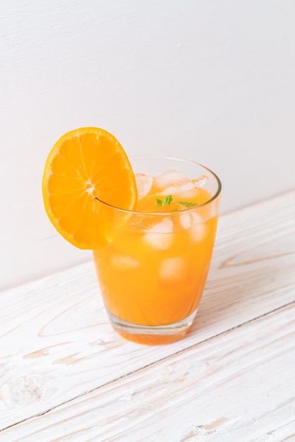 glass of orange juice with ice