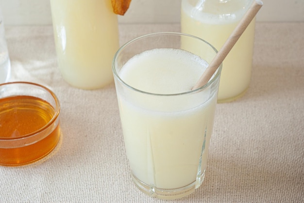 A glass of orange juice with a straw