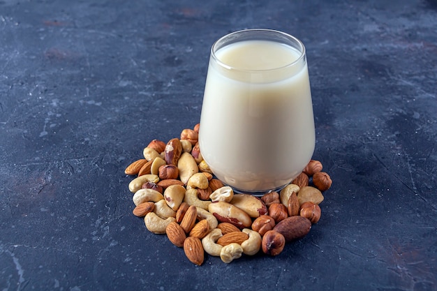 Glass of organic vegan dairy free milk from nuts. vegetarian alternative drink.