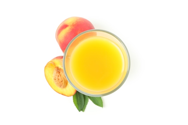 Glass of peach juice and ingredients isolated on white background