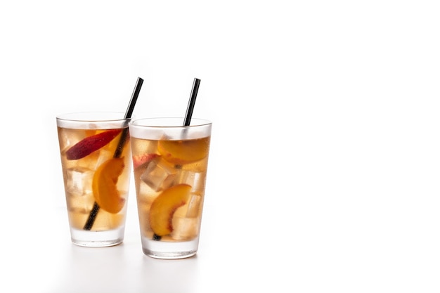 Glass of peach tea with ice cubes isolated on white background Copy space