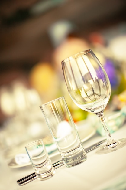 Glass pile glass highbowl and wine glass on the background of a decorated served table