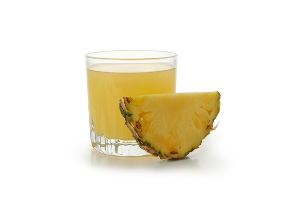 Glass of pineapple juice and slice isolated on white background