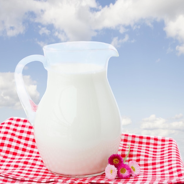 Glass pitcher full of milk