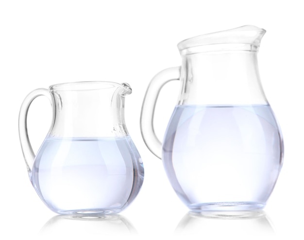 Glass pitchers of water isolated on white