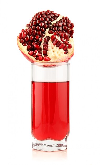 Glass of  pomegranate juice with sliced fruits isolated