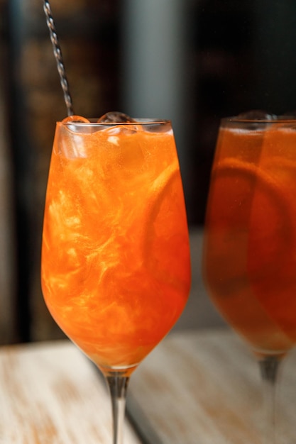 Glass of prosecco with citrus and ice on the table