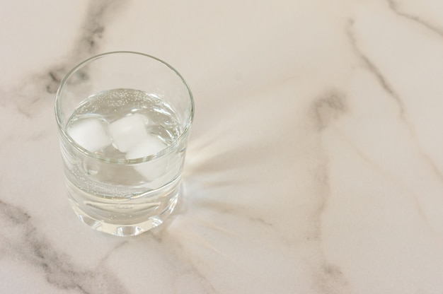 A glass of purified fresh drinking water on a marble table. copy space for text.